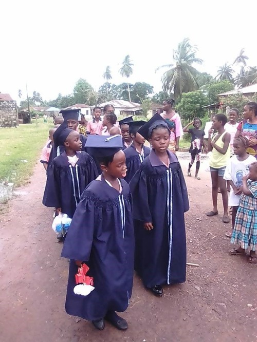 The graduands singing the graduation song, as they march on